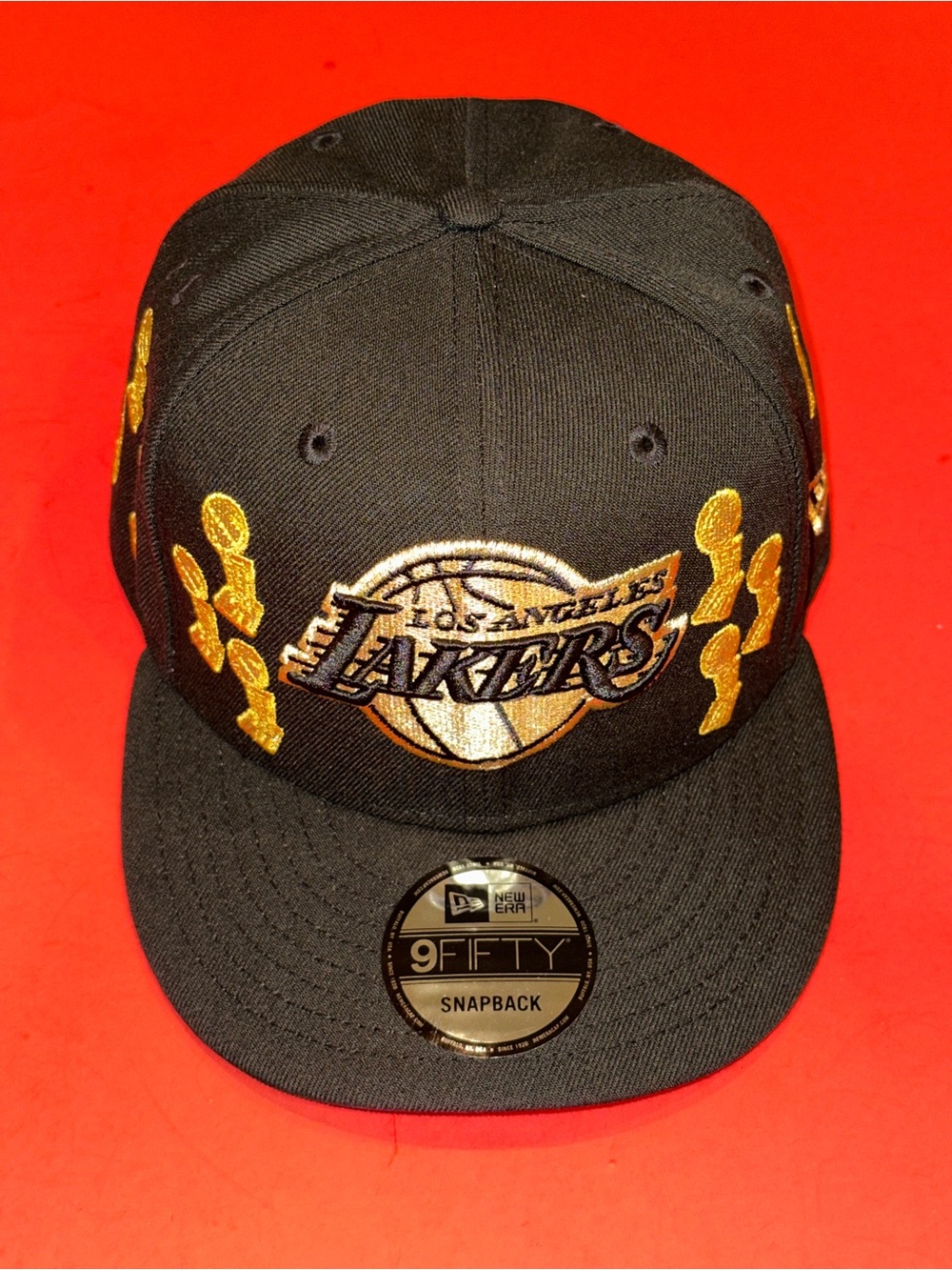 NEW ERA 9FIFTY LOS ANGELES LAKERS GOLD TROPHIES SNAPBACK CAP OSFA